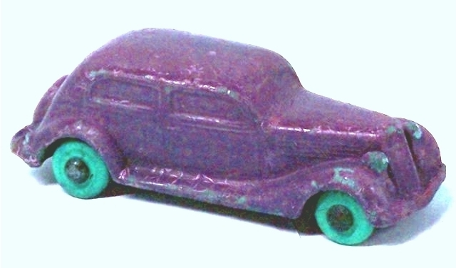 Seiberling autos are very hard to photograph. The colors seemingly dissolve into individual dots and nothing can be done to make them right. This photo is my protest against this problem. A 1935 Ford two door sedan with a slant back and trunk lid mounted spare is shown is bright purple with turquoise tires. It's an eye-catcher.